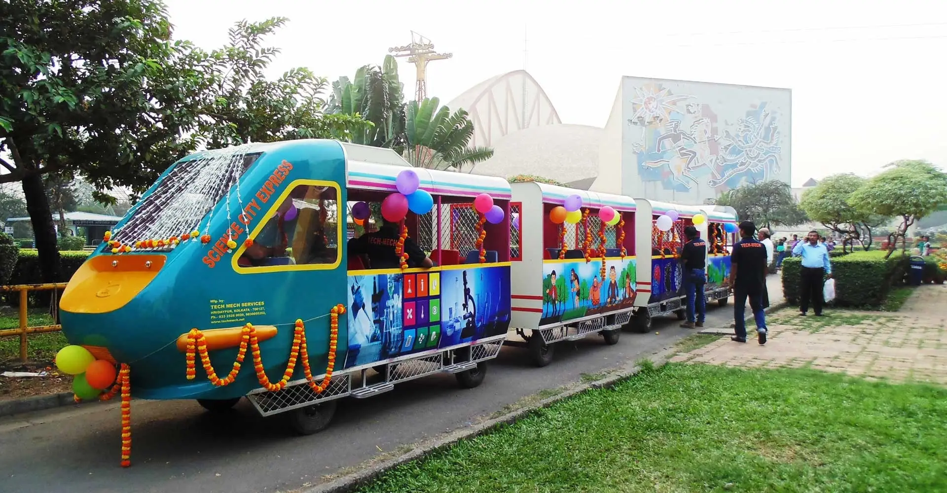 The Science City Express, a bullet-train-styled electric toy train built by Tech Mech, decorated with garlands and balloons